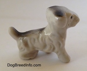 The right side of a bone china Wire Fox Terrier figurine. The figurine has hair details along its body.