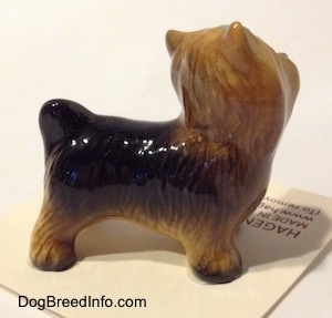 The right side of a black with brown Yorkshire Terrier figurine. The figurine has fine hair brushings along its body.